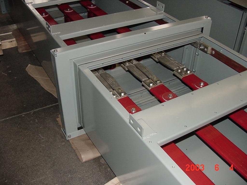 Open metal bus duct assemblies showing insulated conductors and connections